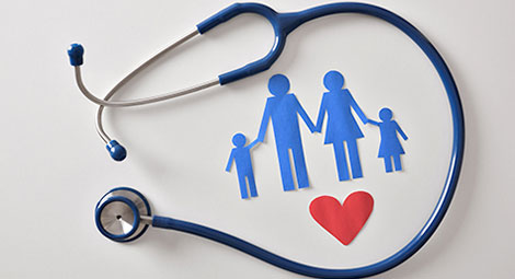 Stethoscope around a papercut out of a family and a heart