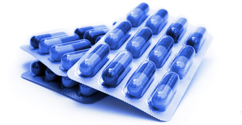 Packets of medication with blue packaging